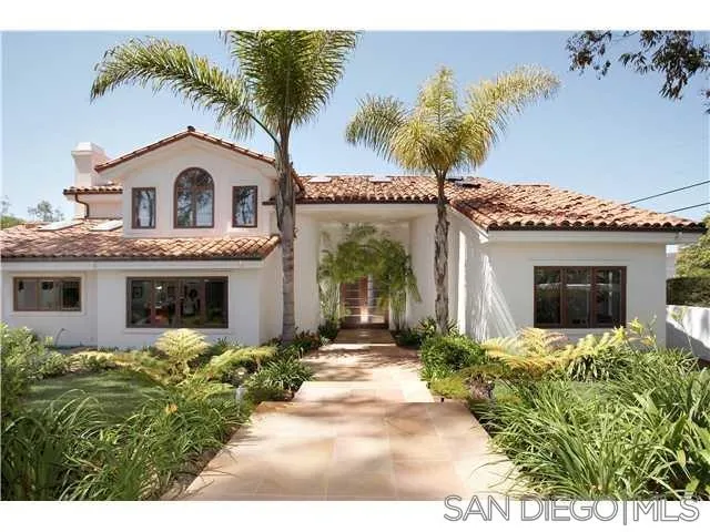 980 Crest Road Del Mar, CA 92014 - Photo 2 of 13 a front view of a house with a yard and garage
