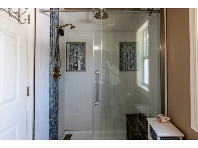 a bathroom with a glass door shower