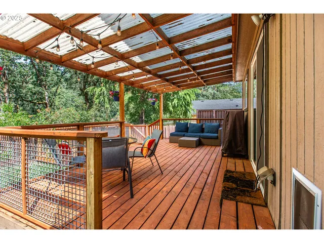 a view of a house with backyard porch and wooden fence