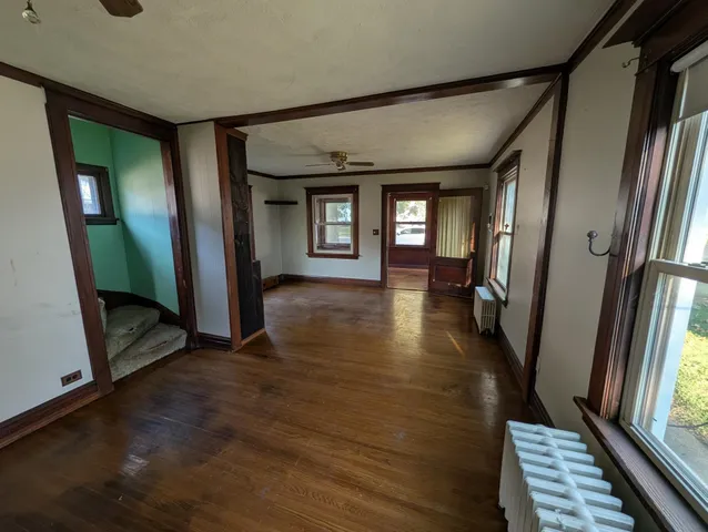a view of a hallway view with wooden floor and staircase