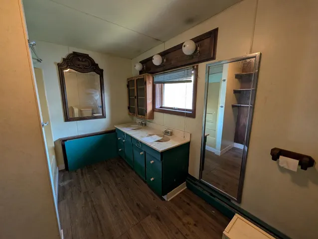 a room with wooden floor and window