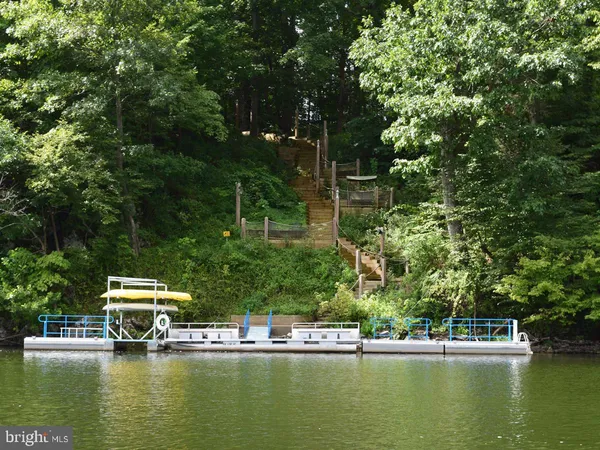 a view of a lake with houses in the back