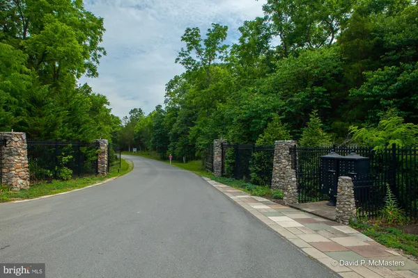 a view of a street with a wooden fence