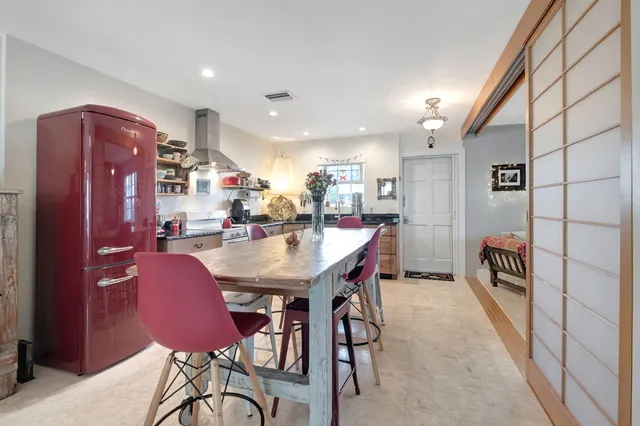 a dining room with furniture and a chandelier