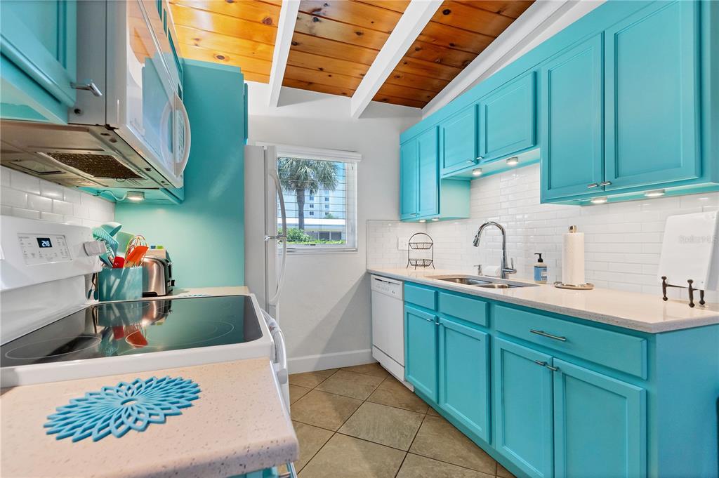 6006 Midnight Pass Road, Unit 16 Sarasota, FL 34242 - Photo 11 of 52 a kitchen with cabinets and a sink