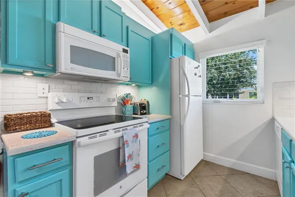 a kitchen with stainless steel appliances white cabinets and a stove top oven