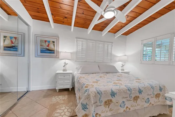 a bedroom with a bed and a painting on the wall