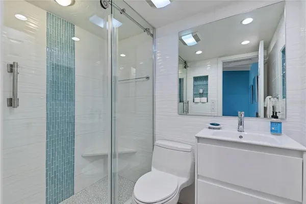 a bathroom with a sink toilet and shower