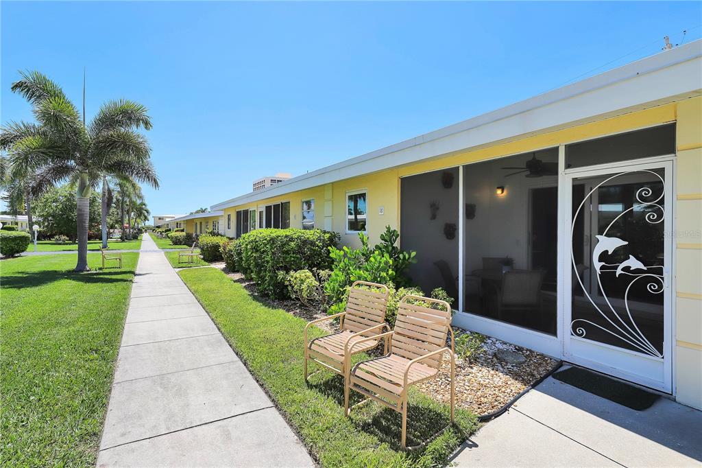 6006 Midnight Pass Road, Unit 16 Sarasota, FL 34242 - Photo 21 of 52 a front view of a house with garden