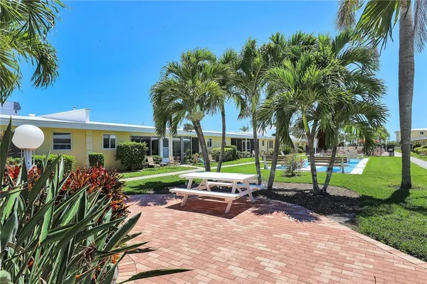 a view of a house with backyard and sitting area