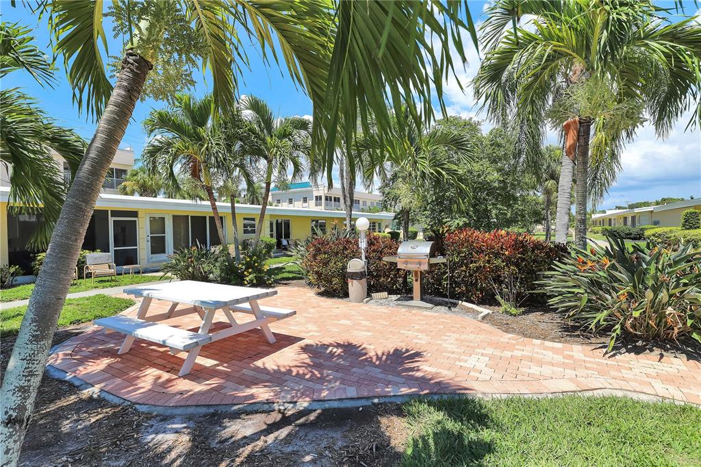6006 Midnight Pass Road, Unit 16 Sarasota, FL 34242 - Photo 26 of 52 a view of a house with a yard