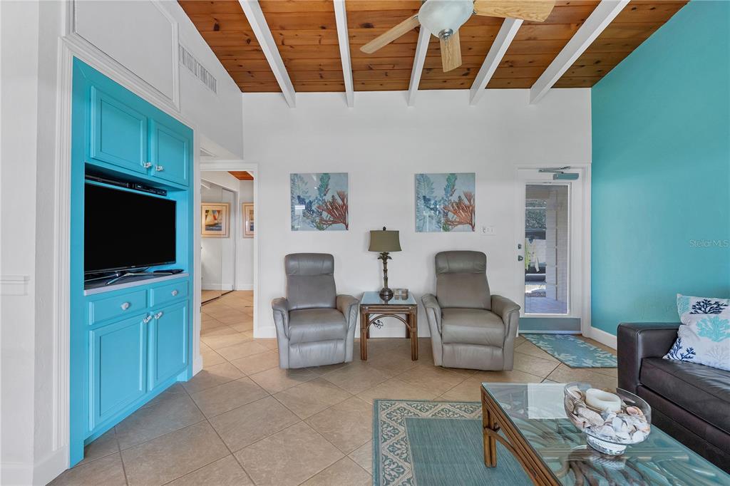 6006 Midnight Pass Road, Unit 16 Sarasota, FL 34242 - Photo 7 of 52 a living room with furniture and a flat screen tv