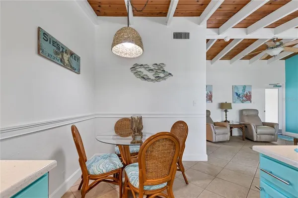a view of a dining room that has a table and chairs in it