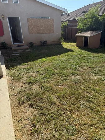 a view of a backyard with plants and potted plants