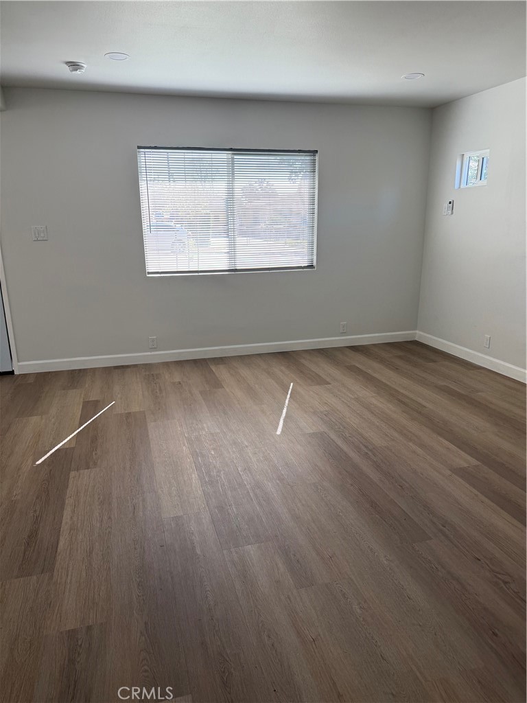 2315 11th Street Riverside, CA 92507 - Photo 2 of 16 an empty room with wooden floor and windows