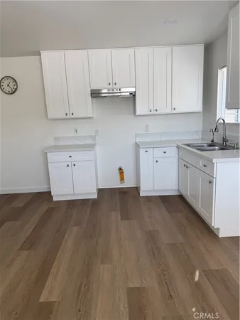 a kitchen with cabinets appliances a sink and dishwasher