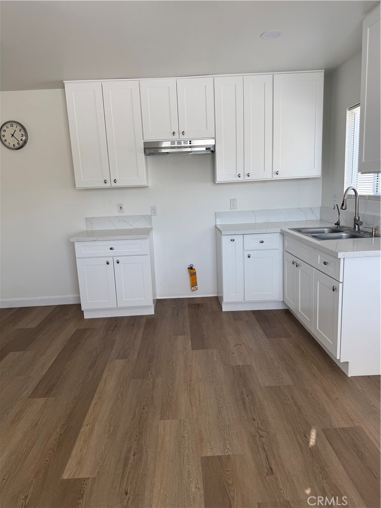 2315 11th Street Riverside, CA 92507 - Photo 4 of 16 a kitchen with cabinets appliances a sink and dishwasher