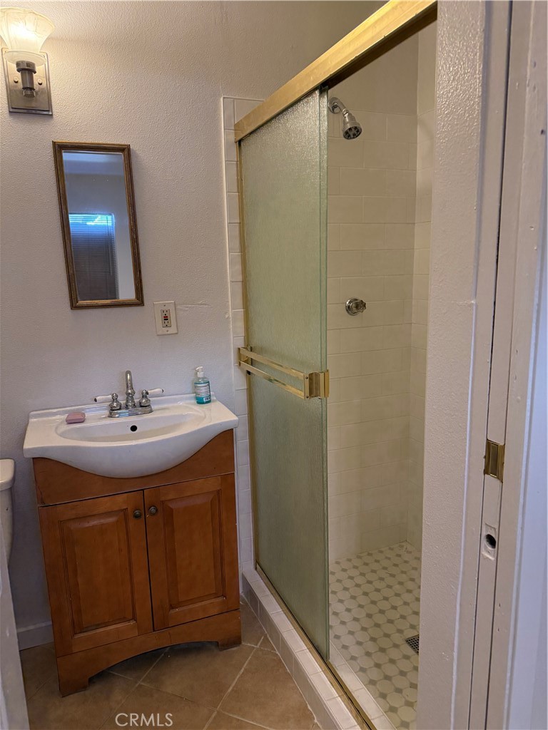 2315 11th Street Riverside, CA 92507 - Photo 10 of 16 a bathroom with a sink and a mirror