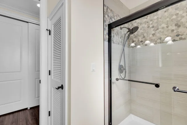 a bathroom with a glass shower door
