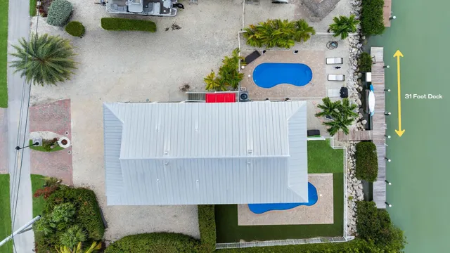 a view of a patio with a table and chairs under an umbrella