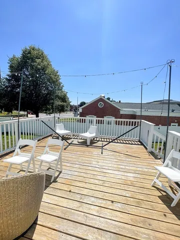 a view of a house with wooden deck