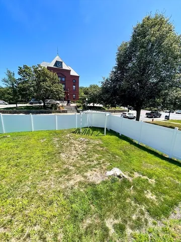 a view of a swimming pool with a yard
