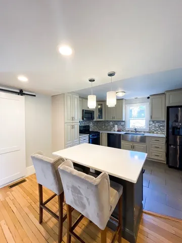 a large kitchen with a table and chairs