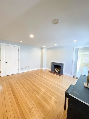 a large white bedroom with a bed and a table in it