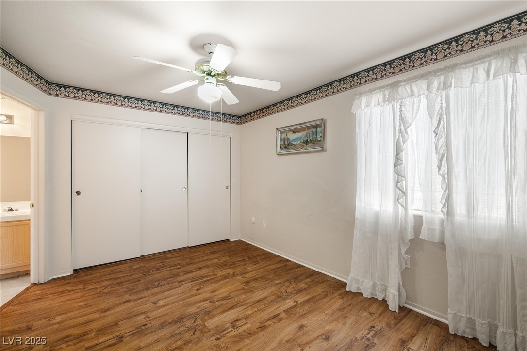 7950 West Flamingo Road, Unit 1024 Las Vegas, NV 89147 - Photo 19 of 30 Unfurnished bedroom featuring wood finished floors
