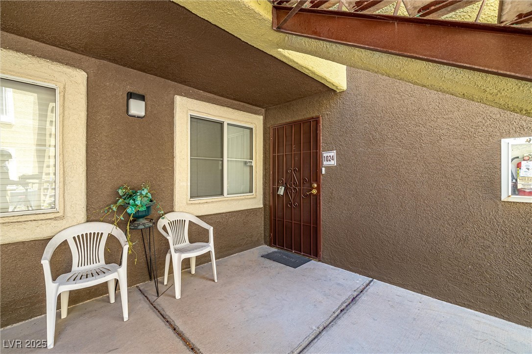 7950 West Flamingo Road, Unit 1024 Las Vegas, NV 89147 - Photo 4 of 30 Doorway to property with stucco siding