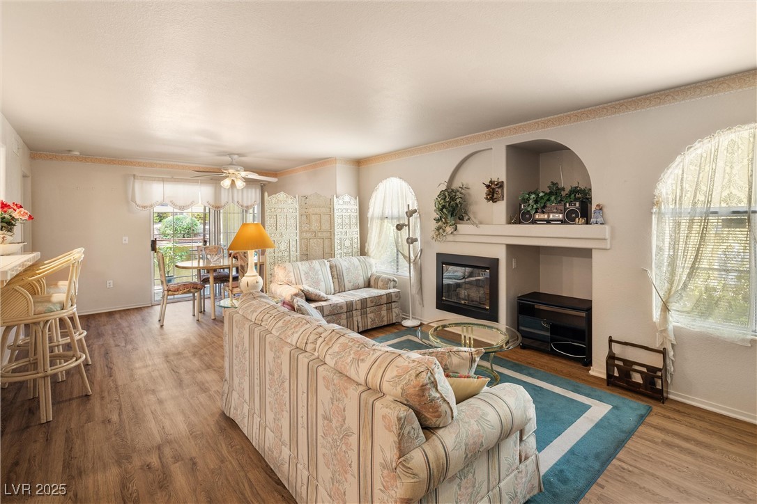 7950 West Flamingo Road, Unit 1024 Las Vegas, NV 89147 - Photo 5 of 30 Living room featuring a glass covered fireplace, w