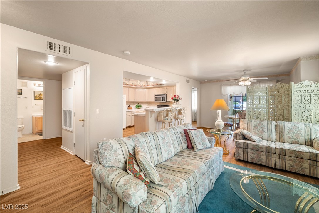 7950 West Flamingo Road, Unit 1024 Las Vegas, NV 89147 - Photo 7 of 30 Living room featuring light wood-type flooring and