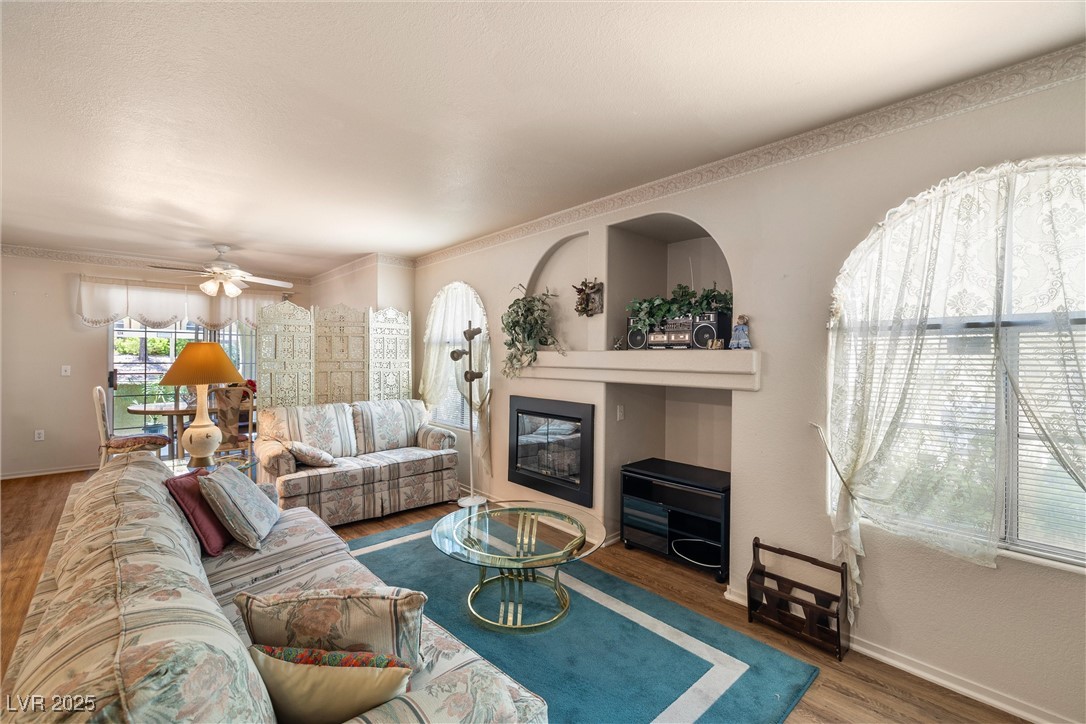 7950 West Flamingo Road, Unit 1024 Las Vegas, NV 89147 - Photo 8 of 30 Living room with a glass covered fireplace, wood f
