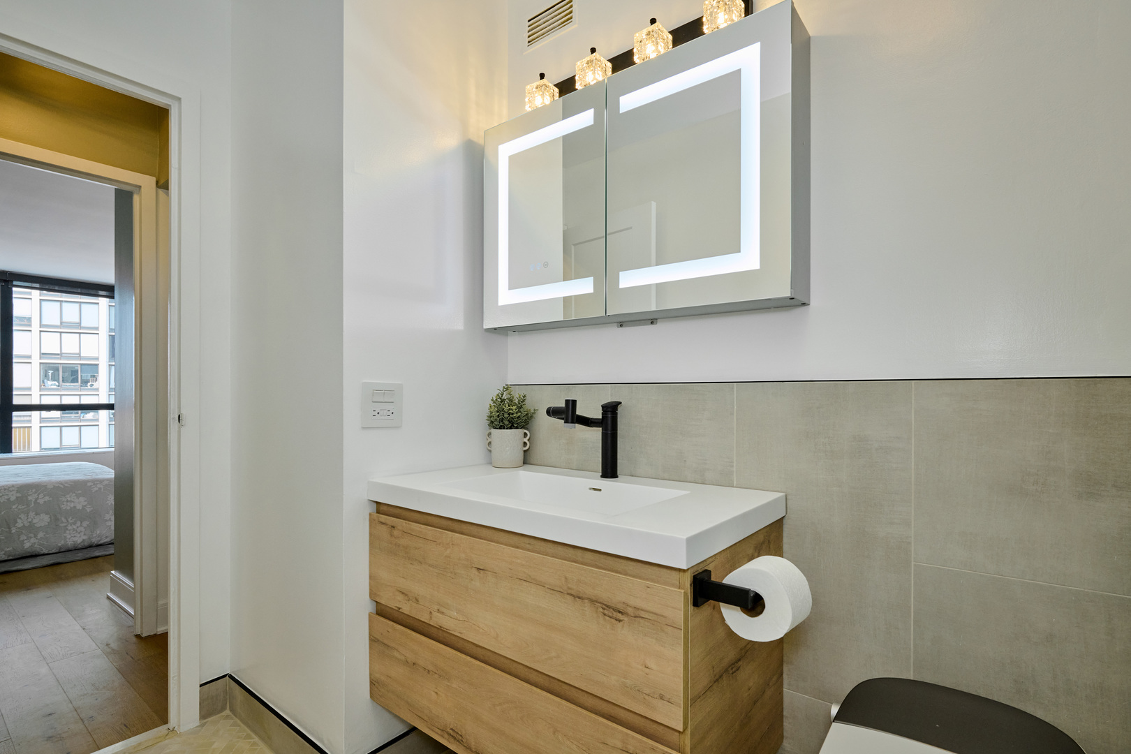 5415 North Sheridan Road, Unit 1908 Chicago, IL 60640 - Photo 16 of 45 a bathroom with a sink mirror and vanity