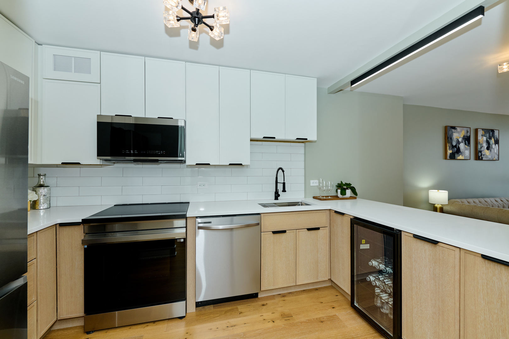 5415 North Sheridan Road, Unit 1908 Chicago, IL 60640 - Photo 2 of 45 a kitchen with stainless steel appliances a stove a sink and a microwave