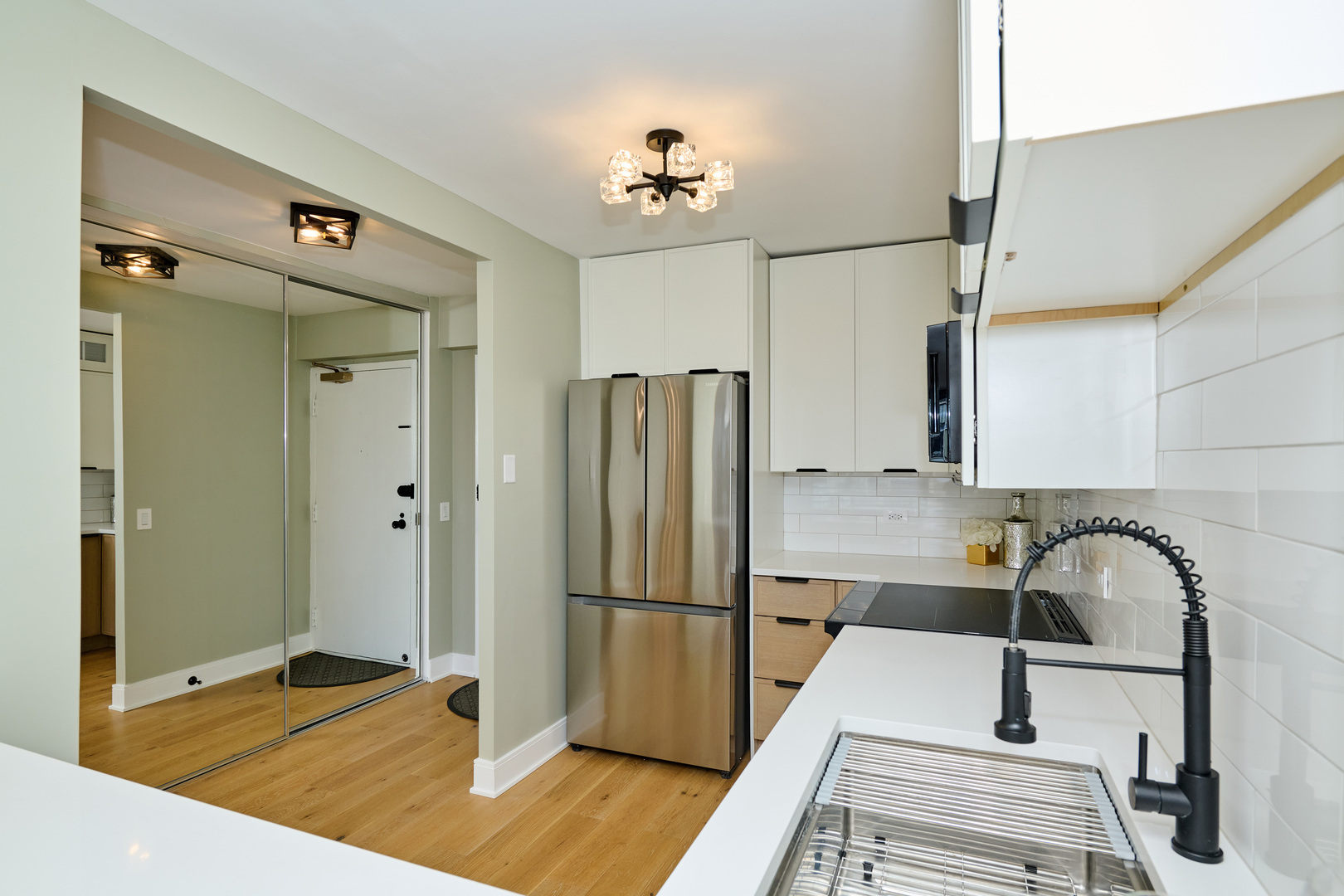 5415 North Sheridan Road, Unit 1908 Chicago, IL 60640 - Photo 26 of 45 a kitchen with stainless steel appliances granite countertop a refrigerator and a sink