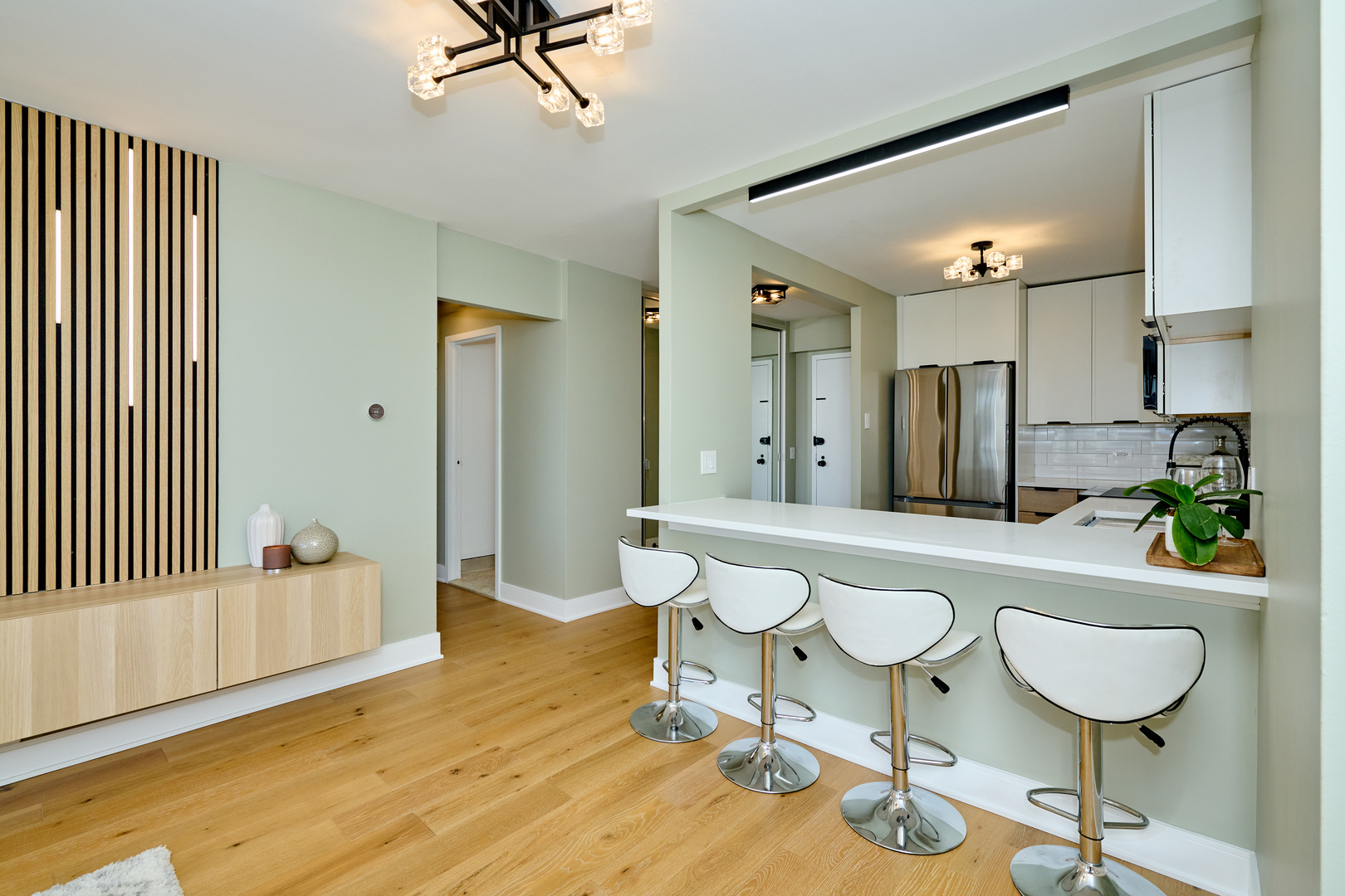 5415 North Sheridan Road, Unit 1908 Chicago, IL 60640 - Photo 10 of 45 a living room with a couch and a chandelier