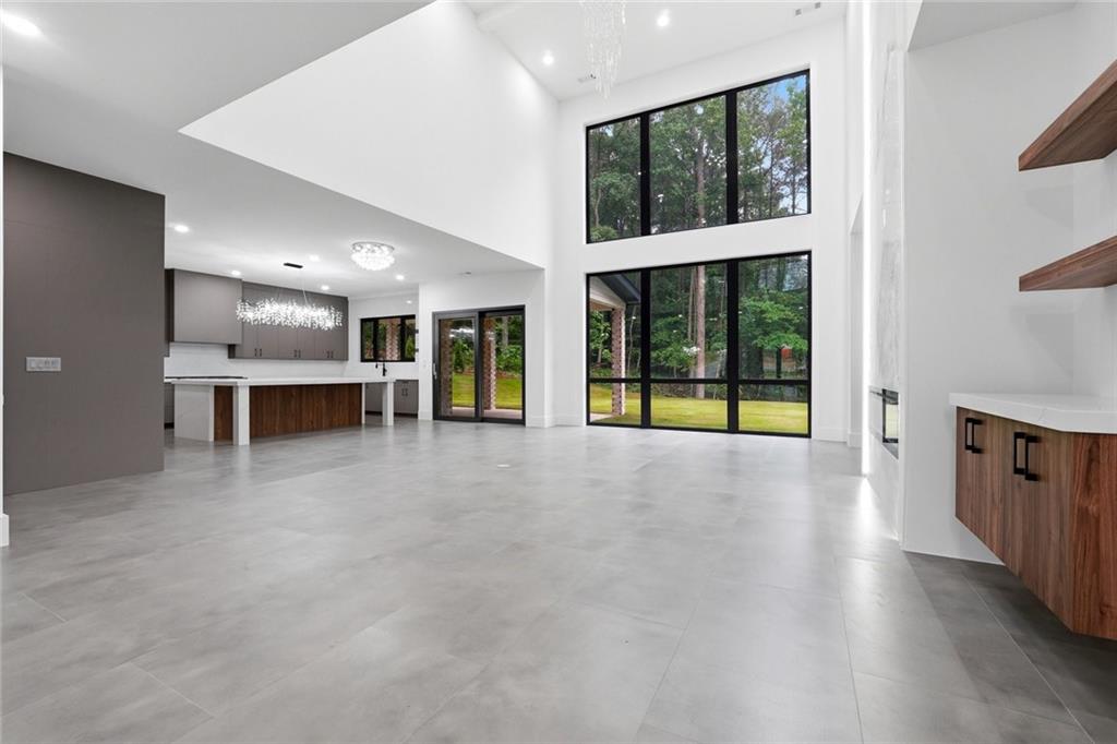 1563 Whitley Road Dacula, GA 30019 - Photo 9 of 44 an empty room with wooden floor and windows