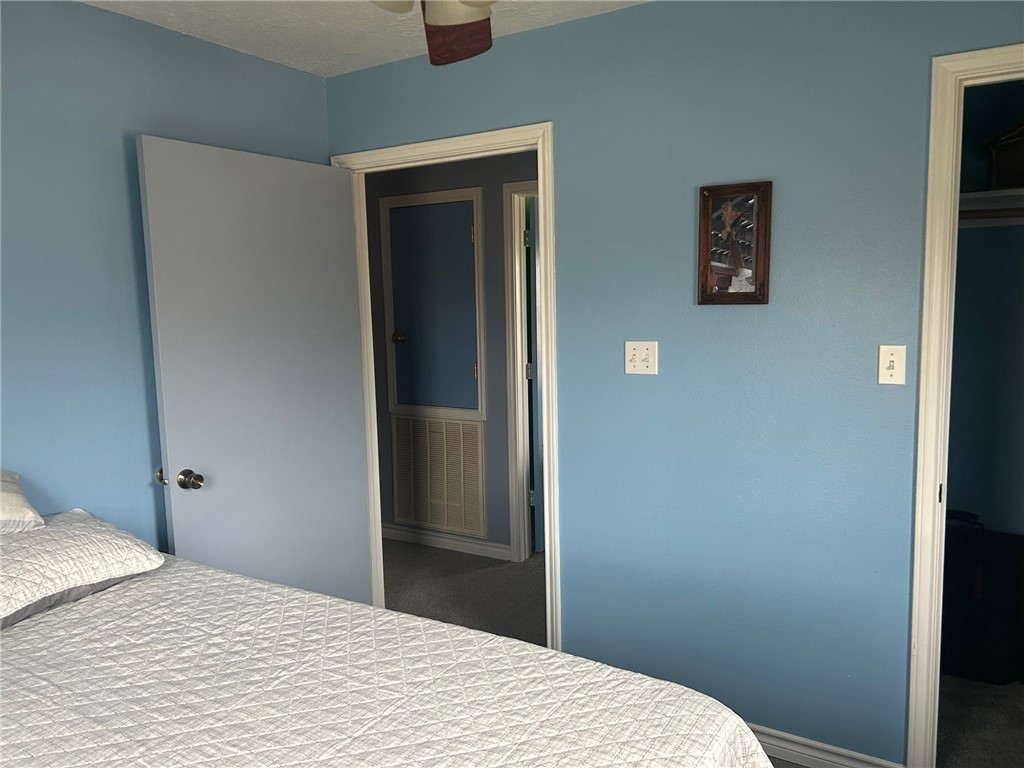 11525 4th Street North Zulch, TX 77872 - Photo 9 of 21 a bedroom with a bed and a wall painting