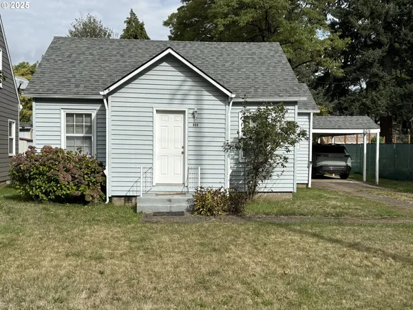 a view of a house with a yard and garage