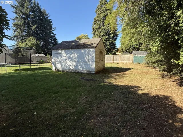 a view of a big yard with large trees