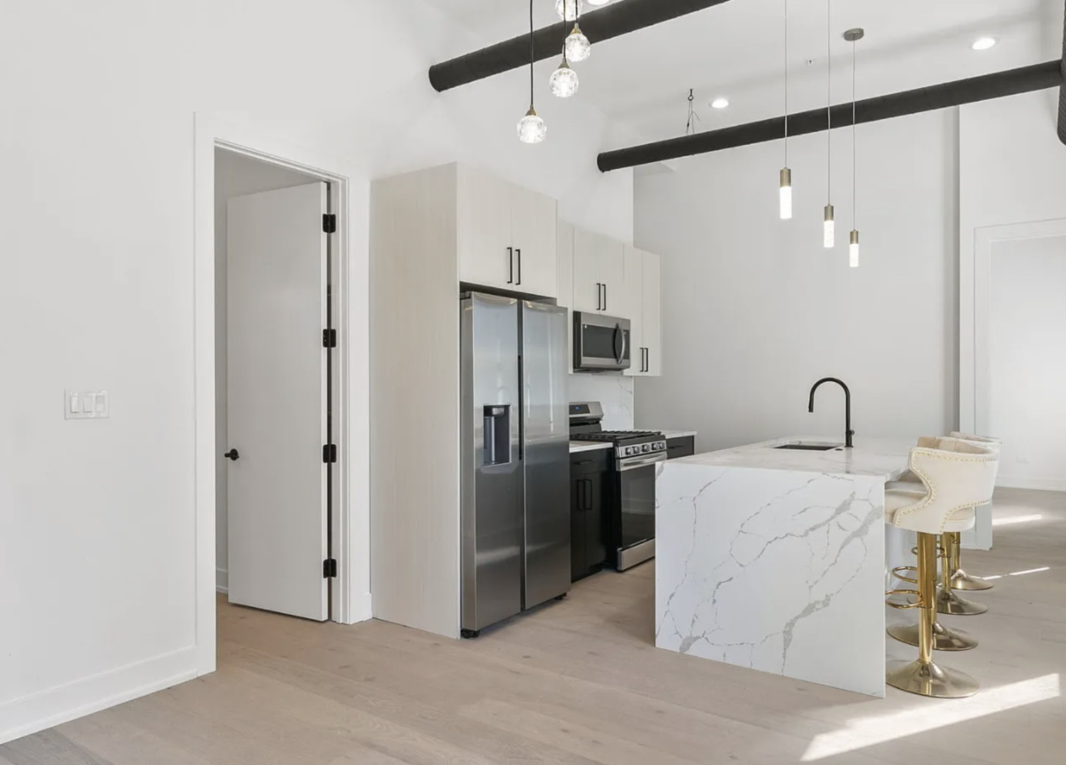 77 West Chestnut Street, Unit 2A Chicago, IL 60610 - Photo 7 of 13 a kitchen with stainless steel appliances kitchen island a refrigerator sink and stove