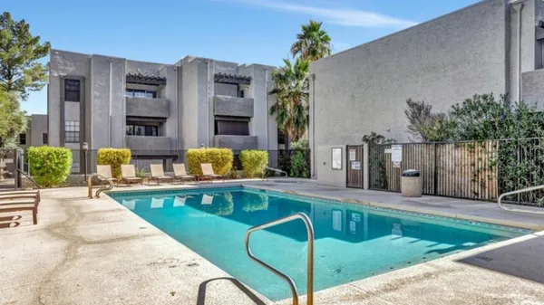 a view of a swimming pool with sitting area