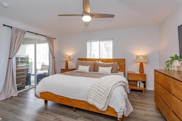 a room with gym equipment and wooden floor