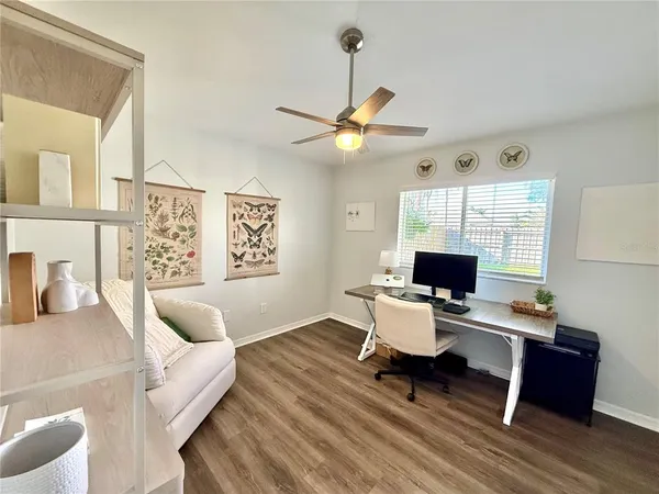 a living room with furniture and a wooden floor