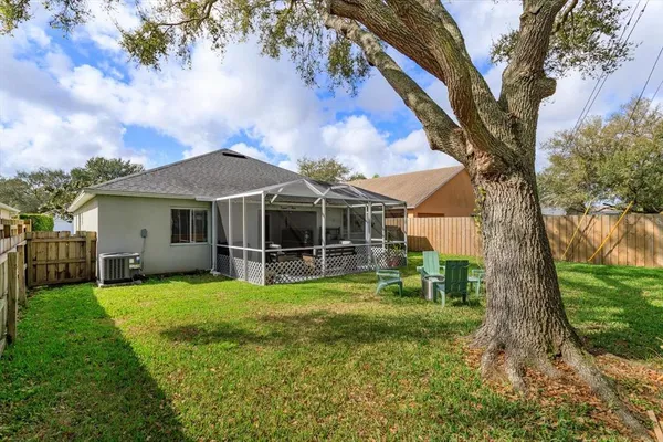 a view of a house with pool and a yard