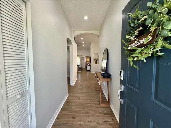 a view of a hallway with wooden floor and stairs
