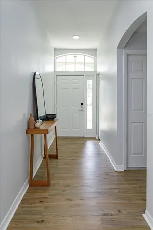 a view of a room with wooden floor and furniture
