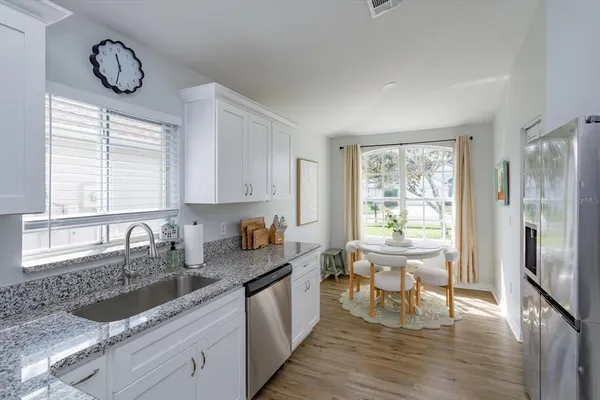 a kitchen with a stove a sink and a refrigerator