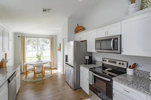 a kitchen with a sink stove and refrigerator